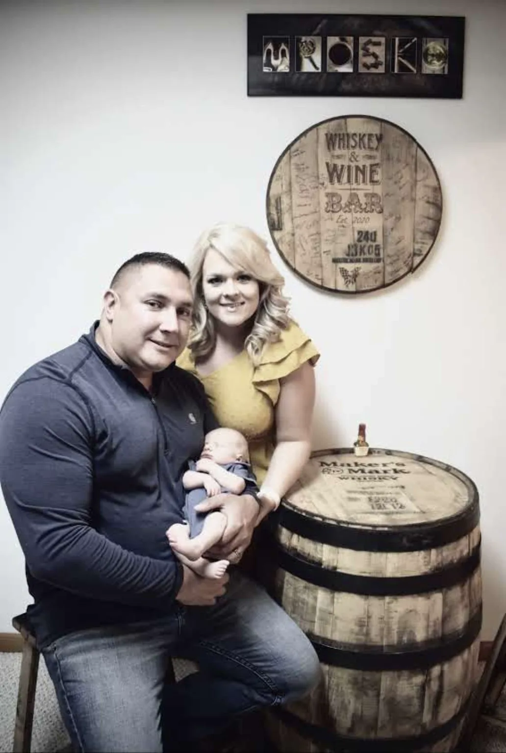 Family portrait with the custom Whiskey and Wine Bar barrel head