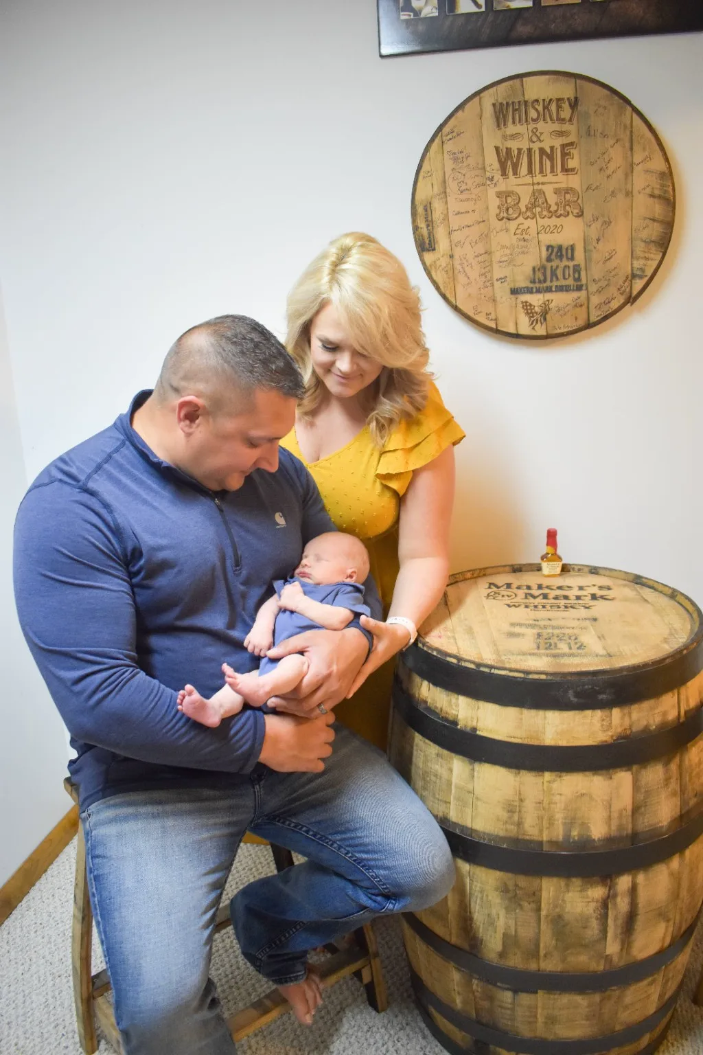 Family portrait beside the custom bourbon barrel display